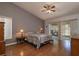 Main bedroom with wood floors and sliding door to backyard at 3127 Ivyhill Ct, Holiday, FL 34691