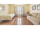 Bedroom with hardwood floors, sofa and window with curtains at 3127 Ivyhill Ct, Holiday, FL 34691