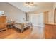 Main bedroom with wood floors and sliding door access to patio at 3127 Ivyhill Ct, Holiday, FL 34691