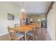 Dining area with hardwood floors, wooden table and access to the living room at 3127 Ivyhill Ct, Holiday, FL 34691