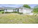 House exterior showcasing landscaping and a two-car garage at 3127 Ivyhill Ct, Holiday, FL 34691