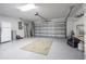 Clean garage with overhead storage and door at 3127 Ivyhill Ct, Holiday, FL 34691