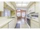 Clean and bright kitchen with white cabinets, and ample counter space at 3127 Ivyhill Ct, Holiday, FL 34691