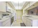 Kitchen with white cabinets, appliances, and tile floor at 3127 Ivyhill Ct, Holiday, FL 34691