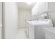 Bright laundry room with washer, dryer, and storage cabinets at 3127 Ivyhill Ct, Holiday, FL 34691