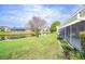 Backyard pond view with surrounding homes at 3127 Ivyhill Ct, Holiday, FL 34691