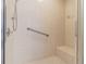 Walk-in shower with tiled walls and seat at 3127 Ivyhill Ct, Holiday, FL 34691