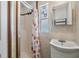 Small bathroom with shower stall, sink, and window at 37015 Sandra Ave, Zephyrhills, FL 33542