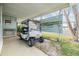 Golf cart parked under the covered carport at 37015 Sandra Ave, Zephyrhills, FL 33542