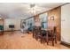 Dining area with wood table and chairs, view of living room at 37015 Sandra Ave, Zephyrhills, FL 33542