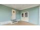Exterior view showing light teal siding, double doors, and entrance at 37015 Sandra Ave, Zephyrhills, FL 33542