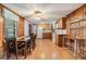 Kitchen with wood cabinets, white appliances, and laminate flooring at 37015 Sandra Ave, Zephyrhills, FL 33542