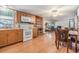 Kitchen with wood cabinets and white appliances at 37015 Sandra Ave, Zephyrhills, FL 33542