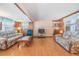 Spacious living room with two sofas and wood flooring at 37015 Sandra Ave, Zephyrhills, FL 33542