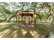 Relaxing wooden swing set under a pergola at 37015 Sandra Ave, Zephyrhills, FL 33542