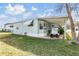 Golf cart parked under covered carport of mobile home at 37015 Sandra Ave, Zephyrhills, FL 33542