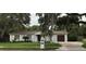 Single-story home with gray exterior, attached garage, and landscaped lawn at 4820 W San Jose St, Tampa, FL 33629
