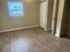 Simple bedroom with wood-look flooring and closet at 5041 54Th N St, St Petersburg, FL 33709