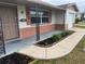 Home's front entrance with walkway, landscaping, and brick accents at 5041 54Th N St, St Petersburg, FL 33709