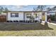 Updated bungalow with modern facade, landscaping, and a wood fence at 5712 3Rd N Ave, St Petersburg, FL 33710