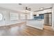 Living room with hardwood floors, open to kitchen, and view of front door at 5712 3Rd N Ave, St Petersburg, FL 33710