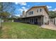 House exterior showcasing a large backyard and screened patio at 6070 Oakhurst Dr, Seminole, FL 33772