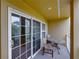 Private balcony with glass-top table and chairs, offering a relaxing outdoor space at 8958 White Sage Loop, Lakewood Ranch, FL 34202