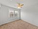 Bright bedroom with ceiling fan and large window at 8958 White Sage Loop, Lakewood Ranch, FL 34202