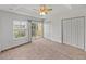 Bright bedroom with ceiling fan, walk-in closet and balcony access at 8958 White Sage Loop, Lakewood Ranch, FL 34202