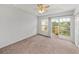 Spacious bedroom with ceiling fan and access to a balcony at 8958 White Sage Loop, Lakewood Ranch, FL 34202
