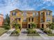 Three-story townhome showcasing architectural details and landscaping at 8958 White Sage Loop, Lakewood Ranch, FL 34202