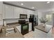 Modern kitchen featuring black appliances and white cabinetry at 8958 White Sage Loop, Lakewood Ranch, FL 34202