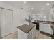 Island kitchen with white cabinets and black appliances at 8958 White Sage Loop, Lakewood Ranch, FL 34202