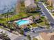 Community pool with adjacent buildings and lake at 8958 White Sage Loop, Lakewood Ranch, FL 34202