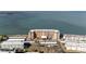 Aerial view of waterfront condo building with parking and ocean views at 9 Haig Pl # 707, Dunedin, FL 34698