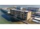 Aerial view of waterfront condo building with parking and water access at 9 Haig Pl # 707, Dunedin, FL 34698