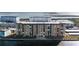 An aerial view of a large condo building near the water at 9 Haig Pl # 707, Dunedin, FL 34698
