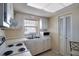 Small kitchen with white cabinets, appliances, and a window at 9 Haig Pl # 707, Dunedin, FL 34698