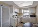 Small kitchen with white cabinets and appliances at 9 Haig Pl # 707, Dunedin, FL 34698