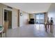 Bright living room with tiled floors, balcony access, and water views at 9 Haig Pl # 707, Dunedin, FL 34698
