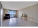Living room with tiled floors and sliding glass doors to balcony at 9 Haig Pl # 707, Dunedin, FL 34698