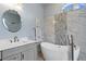 Bathroom with a large soaking tub and double vanity at 10109 Kingshyre Way, Tampa, FL 33647