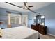 Main bedroom with dresser and view of backyard at 10109 Kingshyre Way, Tampa, FL 33647