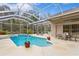 Screened pool and patio with lounge chairs at 10109 Kingshyre Way, Tampa, FL 33647