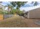 Large backyard with a wooden fence and grassy area at 102 Shoreview Ln, Oldsmar, FL 34677