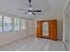 Bright bedroom with tile floors, large windows, and ceiling fan at 102 Shoreview Ln, Oldsmar, FL 34677
