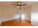 Bedroom with laminate wood floors and ceiling fan at 102 Shoreview Ln, Oldsmar, FL 34677