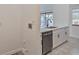 Modern kitchen with white cabinets and stainless steel dishwasher at 102 Shoreview Ln, Oldsmar, FL 34677