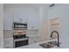 Modern white kitchen with stainless steel appliances at 102 Shoreview Ln, Oldsmar, FL 34677