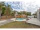 Inviting kidney-shaped pool with concrete patio at 102 Shoreview Ln, Oldsmar, FL 34677